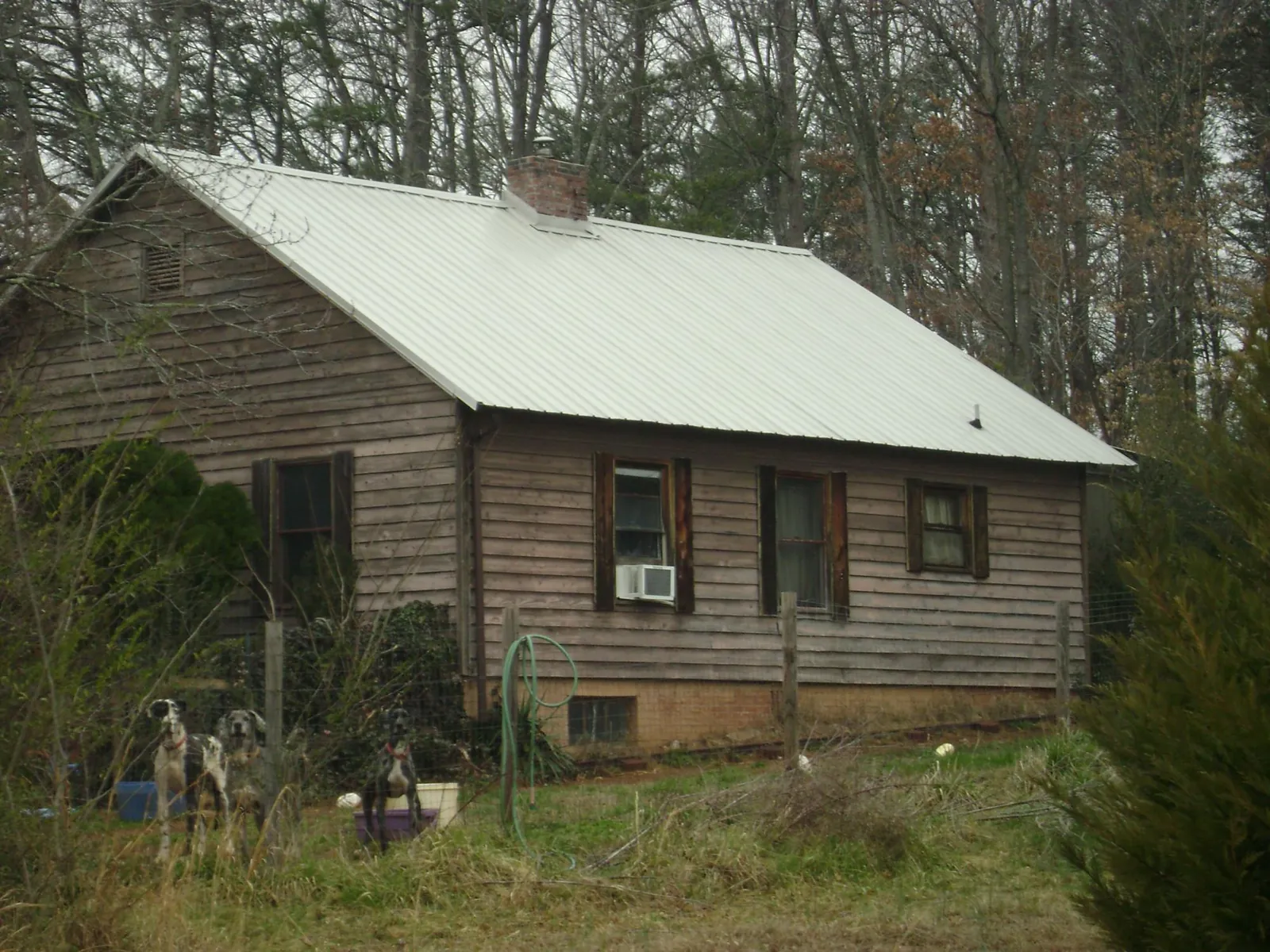 White metal roof on an old wood sided farmhouse, from a Asphalt Shingle Roof Repair job in Weogufka
